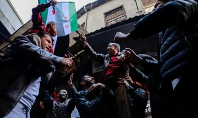 People celebratein Damascus after rebel fighters ousted Syria’s Bashar al-Assad