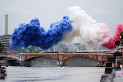 Smoke resembling the flag of France billows above the Pont d’Austerlitz bridge during the opening ceremony of the Paris 2024 Olympic Games (John Walton/PA).