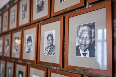 This photo taken on September 25, 2024 shows a portrait of South African anti-apartheid activist and statesman Nelson Mandela (1918-2013), Nobel Peace Prize laureate of 1993, next to other photographs on a wall of the committee meeting room at the Norwegian Nobel Institute in Oslo, Norway. AFP PHOTO