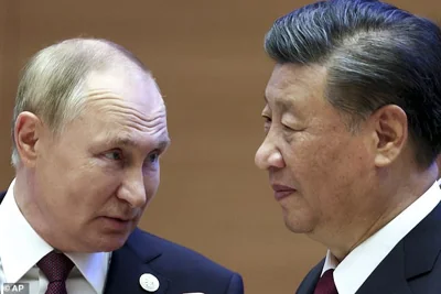 Russian President Vladimir Putin, left, speaks to Chinese President Xi Jinping