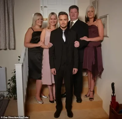 In the video Liam is dressed up and surrounded by his sisters Nicole and Ruth, as well as his mother and father, Geoff and Karen