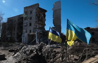 Ukrainian flags wave in front of damaged residential buildings in Orikhiv, near the frontline in the Zaporizhzhia region, Ukraine