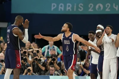 United States' Stephen Curry (4) and LeBron James (6) celebrate after beating France to win the gold medal during a men's gold medal basketball game at Bercy Arena at the 2024 Summer Olympics, Saturday, Aug. 10, 2024, in Paris, France. AP PHOTO