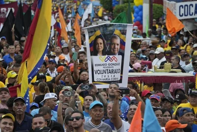 A supporter holds up a banner with images of opposition leader Maria Corina Machado and presidential candidate Edmundo Gonzalez, during a campaign rally in Venezuela.