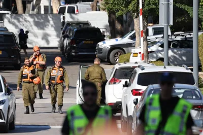 Members of the Israeli security forces walk along a street leading to Prime Minister Benjamin Netanyahu's residence in Caesarea on October 19, 2024. Netanyahu's office said a drone was launched toward his residence on October 19, after the military reported a drone from Lebanon had "hit a structure" in the central Israeli town. (Photo by Jack GUEZ / AFP)