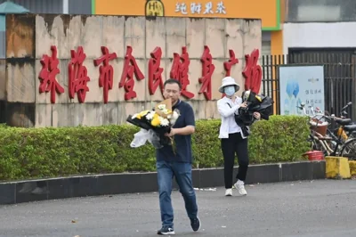 LEAVE NO TRACE Workers remove flowers from a makeshift memorial outside the Zhuhai Sports Center in the city of Zhuhai, Guangdong province, southern China, on Nov. 13, 2024, two days after a man drove a car into a crowd and killed 35 people. AFP PHOTO