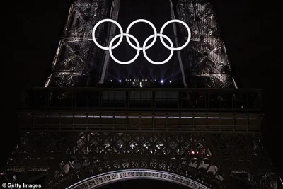 The music legend performed an Edith Piaf classic from the country's most famous landmark as the Olympics were launched for 2024