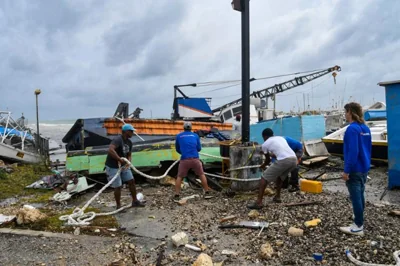 Fishermen attempt to salvage a damaged fishing boat after the passage of Hurricane Beryl at the Bridgetown Fish Market, Bridgetown, Barbados, Monday. AFP-Yonhap