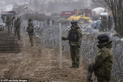 A Trump-negotiated peace deal could see a demilitarised zone implemented across Ukraine (picture shows Polish border forces constructing reinforced border walls)