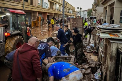 People clean their houses affected by floods in Utiel