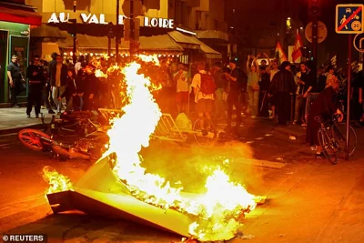 A barricade burns as protesters demonstrate against the French far-right National Rally party