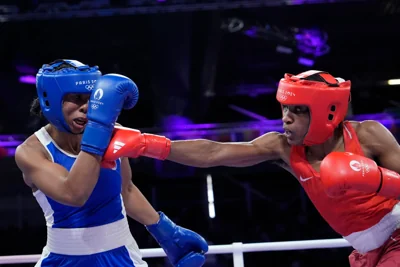 Refugee Olympic Team's Cindy Ngamba hits France's Davina Michel