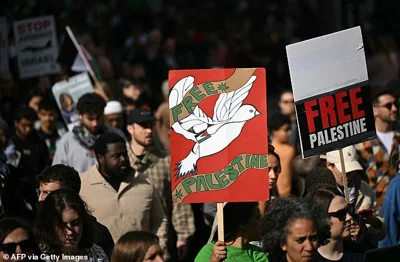 Pro-Palestinian activists and supporters wave flags and hold placards as they pass through central London