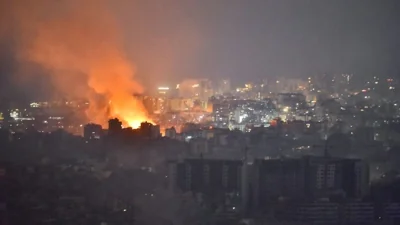 Flames and smoke rise in an area targeted by an Israeli air strike on Beirut's southern suburbs