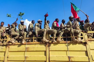 A truck carrying gunmen affiliated with Sudan's army drives on a street in the eastern city of Gedaref