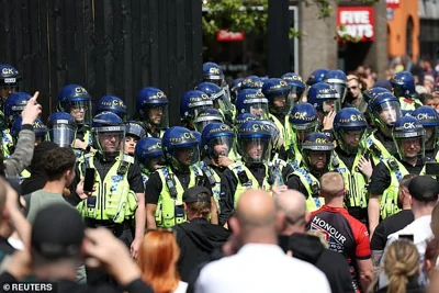 MANCHESTER: Police officers stand guard as people participate in a protest today