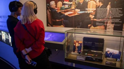 Photographs showing officials, including Russia's incumbent president Vladimir Putin, are on display next to the so-called Russia's nuclear briefcase also known as the "Cheget", which was in use during Russian first President Boris Yeltsin's years in office and could authenticate an order to launch nuclear missiles, at the exposition of the Boris Yeltsin Presidential Centre in Yekaterinburg, Russia, October 18, 2022. REUTERS/Natalia Chernokhatova