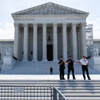 The U.S. Supreme Court building in Washington with police officers standing in front of it.