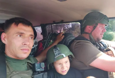 Donetsk-region police officers Vasyl Pipa and Artem Shus during an evacuation mission in a frontline area. Photograph courtesy of Vasyl Pipa