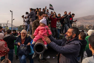 Syrians in Damascus celebrate the collapse of 61-Year Baath Regime