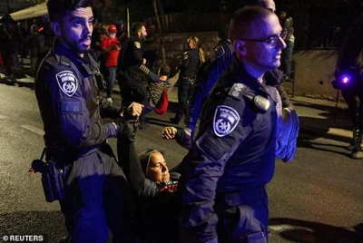 Police members remove a demonstrator from a protest against Israeli Prime Minister Benjamin Netanyahu and his government and for the immediate release of Gaza hostages