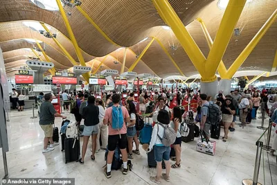 Passengers face huge queues at Madrid's Barajas airport as the global outage disrupted check in systems in the terminal