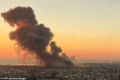 Smoke rises above Beirut's southern suburbs during an Israeli strike on September 27