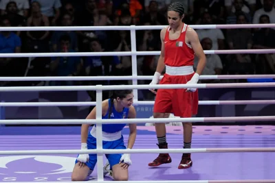 Imane Khelif, right, stands over Angela Carini (John Locher/AP)