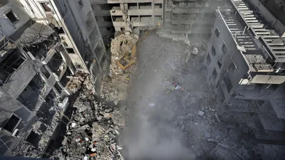 Rescue workers search for victims at the site of an Israeli air strike that hit central Beirut, 23 November, 2024