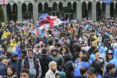 Demonstrators with Georgian national and EU flags gather during an opposition protest against "the Russian law" near the Parliament building in the center of Tbilisi, Georgia, Tuesday, May 14, 2024