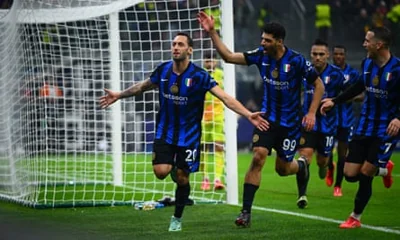 Hakan Calhanoglu of FC Internazionale celebrates with teammates.