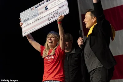 SpaceX and Tesla founder Elon Musk awarded Kristine Fishell with a $1 million check during the town hall at the Roxain Theater on October 20, 2024 in Pittsburgh, Pennsylvania