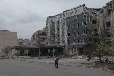 A woman walks in front of Druzhba hotel destroyed by Russian airstrikes in Pokrovsk, Monday, Nov. 11, 2024