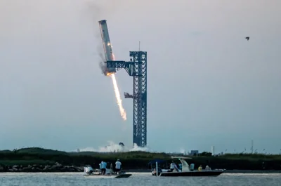 SpaceX successfully "caught" the first-stage booster of its Starship megarocket Sunday as it returned to the launch pad after a test flight, a world first in the company's quest for rapid reusability.