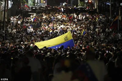 Venezuelan citizens gather to wait for the results of the presidential elections