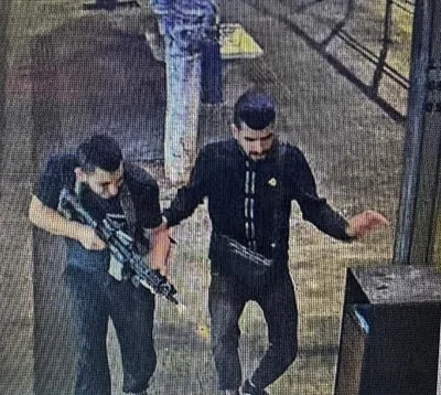 Pictured: Armed men on the streets of Jaffa, Tel Aviv, on Tuesday night