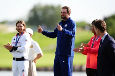 USA’s Scottie Scheffler gives the thumbs up on the podium after winning a gold medal, with Tommy Fleetwood on his right and Hideki Matsuyama on his left (John Walton, PA)