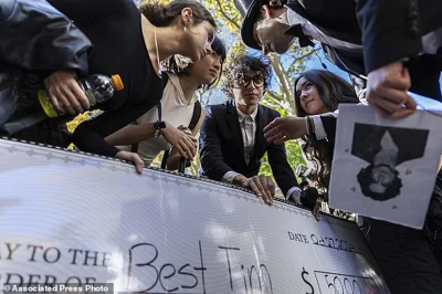 Anthony Po, right, deliberates with the judges at the Timothee Chalamet lookalike contest near Washington Square Park, Sunday, Oct. 27, 2024, in New York