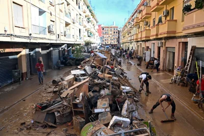 Debris is piled up along a street in the town of Paiporta. Photograph: Jose Jordan/AFP via Getty Images