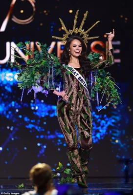 Miss Great Britain dressed up in a leaf-adorned jumpsuit with a huge gold crown to represent the UK's 121 million oak trees