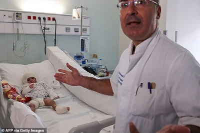 Plastic and reconstruction surgeon Ziad SLeiman checks on two-year-old girl Ivana Skayki, who suffered third-degree burns due to an Israeli strike in southern Lebanon, at Geitaoui Hospital in Beirut on October 30, 2024