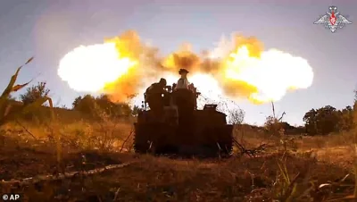 In this photo taken from video released by the Russian Defense Ministry on Aug. 18, 2024, Russian soldiers fire a Giatsint-S gun toward Ukrainian positions at an undisclosed location near the Russian-Ukrainian border area in the Kursk region