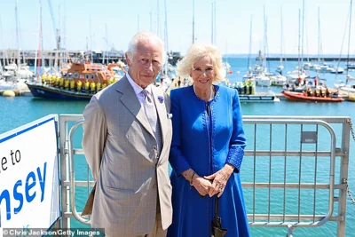 King Charles III And Queen Camilla pose in front of the RNLI Lifeboats during an official visit to Guernsey on July 16