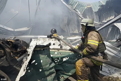 Firefighters put out a fire after a Russian missile hit a large printing house in Kharkiv, Ukraine May 23