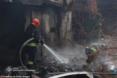 Firefighters work at the site of a Russian missile strike in Dnipro