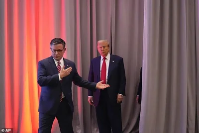 House Speaker Mike Johnson (left) escorts President-elect Donald Trump (right) into a meeting with the House GOP conference on Wednesday