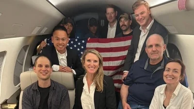 TOPSHOT - In this image released by the US Government, US journalist Evan Gershkovich (L), former US Marine Paul Whelan (2R) and US-Russian journalist Alsu Kurmasheva (R) are seen on a plane after their release from Russia on August 1, 2024. Gershkovich, Whelan, Kurmasheva and Russian opposition activist Vladimir Kara-Murza were part of a 24-prisoner swap with Russia.(AFP)