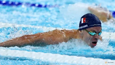 Marchand takes 200 butterfly gold in Olympic record time