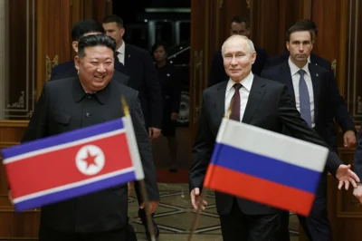 Russian President Vladimir Putin, right, and North Korea's leader Kim Jong Un smile during their meeting at the Pyongyang Sunan International Airport outside Pyongyang, North Korea, on June 19, 2024.