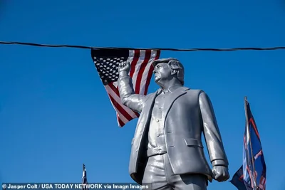 A statue of former President Donald Trump with a raised fist greets supporters before Trump speaks at a campaign rally in Butler, Pa., on October 5, 2024